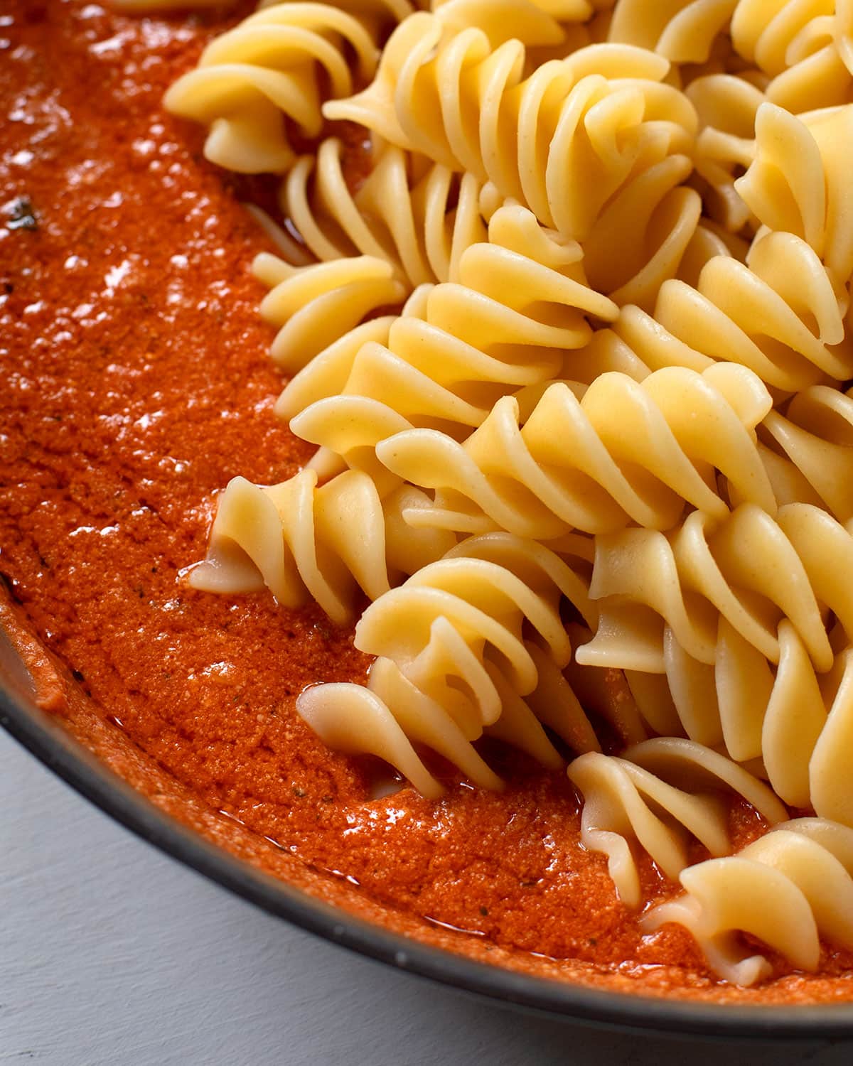 pasta with ricotta and tomato sauce in frying pan