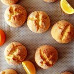 orange cookies on baking parchment