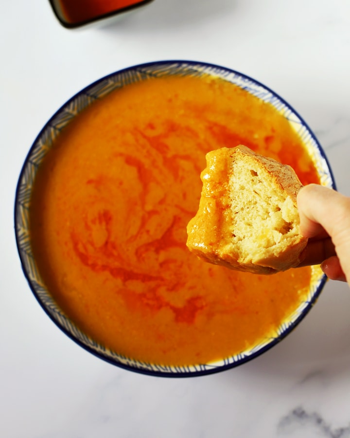 bread dipped into turkish red lentil soup