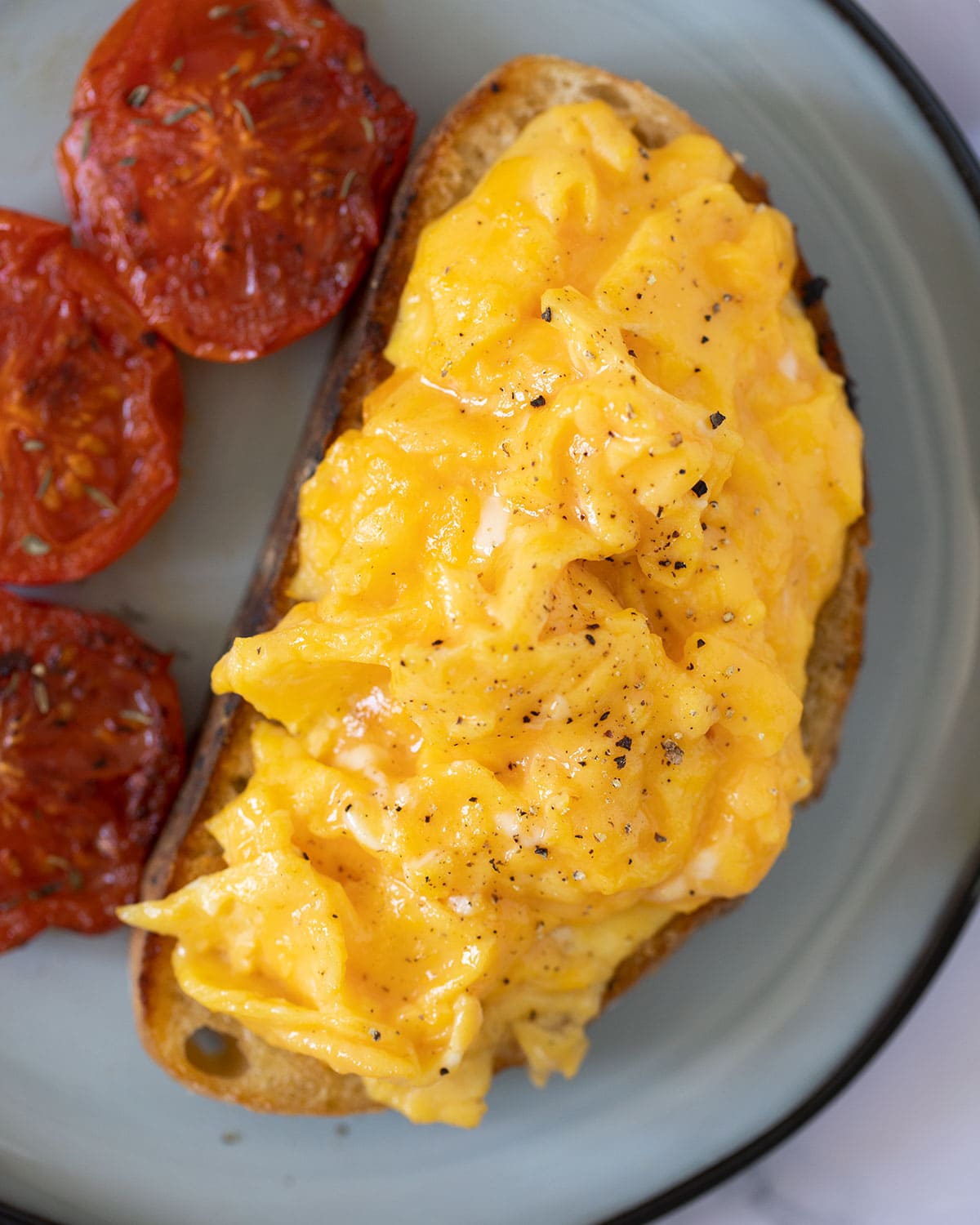 scrambled eggs on toast on a plate