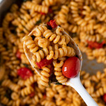 spoonful of burst cherry tomato pasta