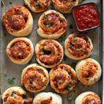 homemade pizza rolls with pizza dough on baking tray