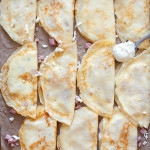 ham and cheese crepes on baking sheet