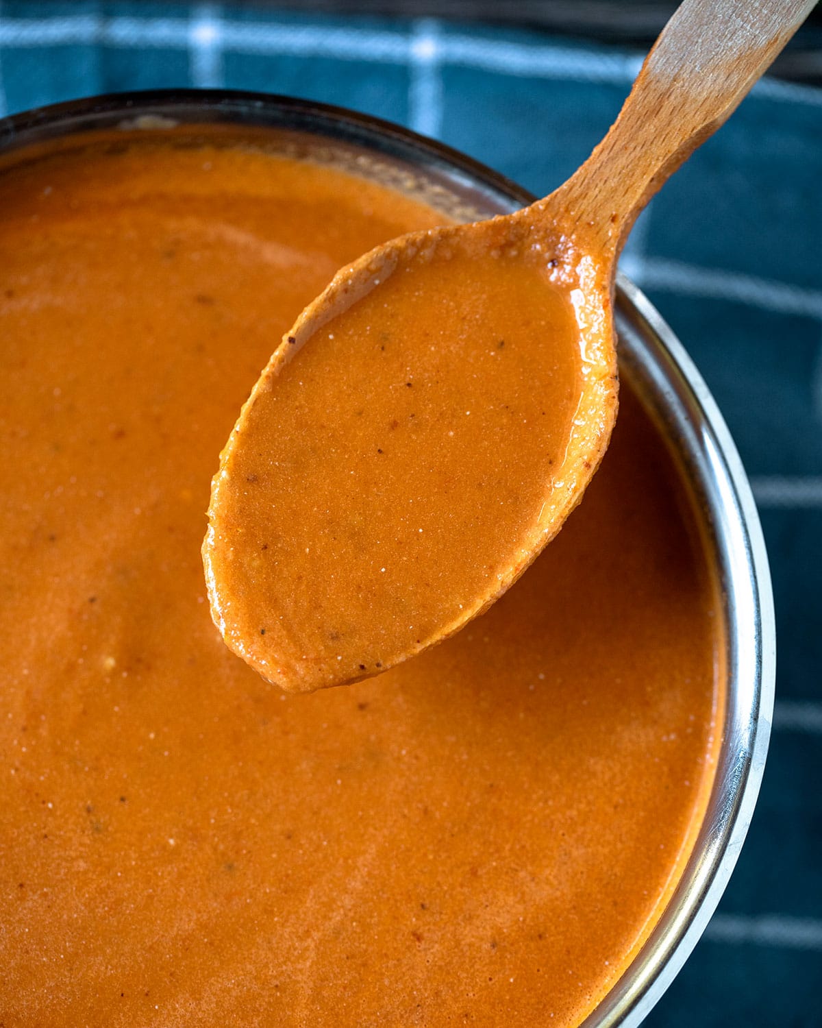 spoonful of roasted tomato soup with fresh tomatoes